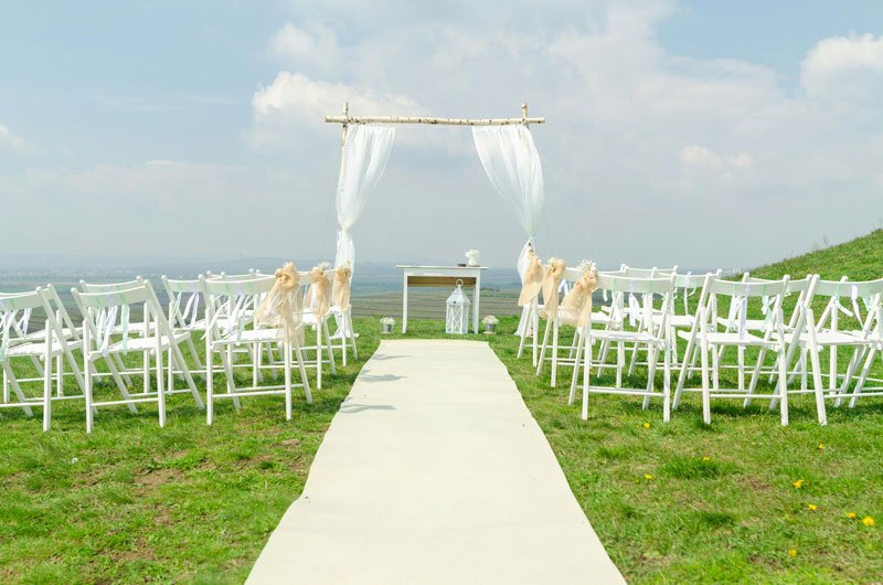 Wedding Altar surrounded by white chairs outdoors with clear skies